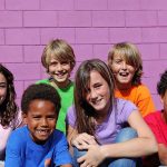 Senator SLAMS Dems: Kids in Danger! A group of six children smiling together in front of a purple wall