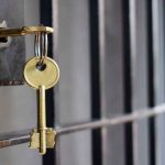 Key in lock of prison cell door.