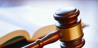 Virginia Voters OVERRULED — Courts Drop The Hammer Gavel resting on sounding block beside open book.