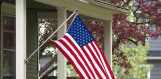 American flag hanging on a porch.
