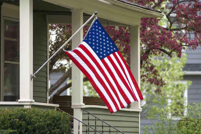 274747697 American flag hanging on a porch.