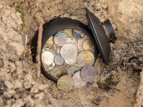 Pot of old coins uncovered in the ground