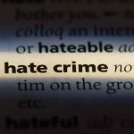 Close-up of a dictionary page showing the definition of 'hate crime'