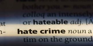 HATE CRIMES SURGE 71% — Guess WHERE! Close-up of a dictionary page showing the definition of 'hate crime'