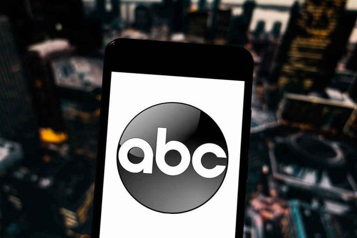 shutterstock_1351717706 A smartphone displaying the ABC logo against an urban backdrop