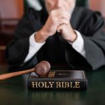 Bishop Charged With UNTHINKABLE CRIME — Trust SHATTERED A judge in a courtroom with a gavel and a Holy Bible on the table