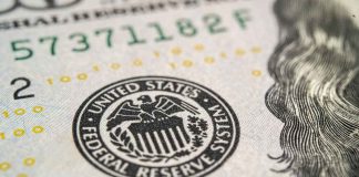 Close-up of a United States dollar bill featuring the Federal Reserve emblem