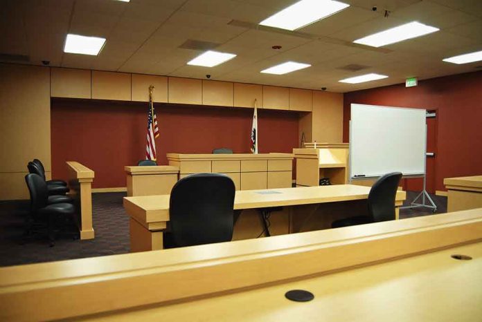 shutterstock_6768826 Interior view of an empty courtroom with wooden furniture and American flags
