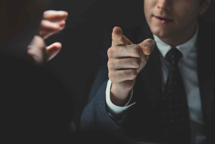 shutterstock_1105694723 Man in suit pointing a finger during a tense conversation