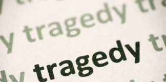 Close-up of the word 'tragedy' printed multiple times in varying shades