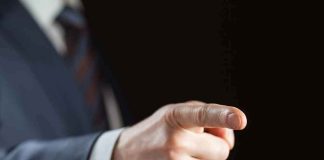 Hand in suit pointing forward