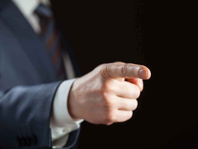 shutterstock_128319779 Hand in suit pointing forward
