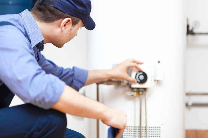 shutterstock_142322101 Plumber adjusting the settings on a water heater