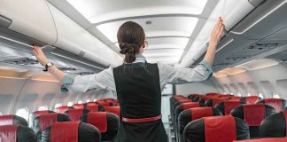 Airline MELTDOWN Over ‘Sharia’ Seat Flight attendant checks overhead bins in empty airplane cabin