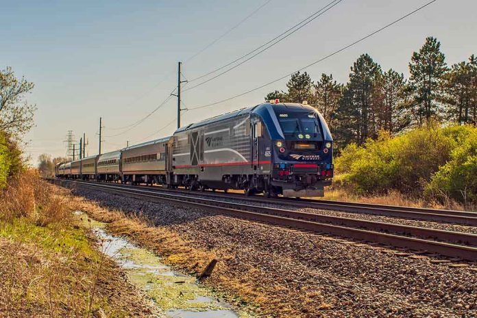 shutterstock_1726705978 Passenger train on rural tracks passing trees