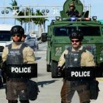 Armed Troops, NO Cameras — Then SHOTS Police officers in riot gear with armored vehicle behind.