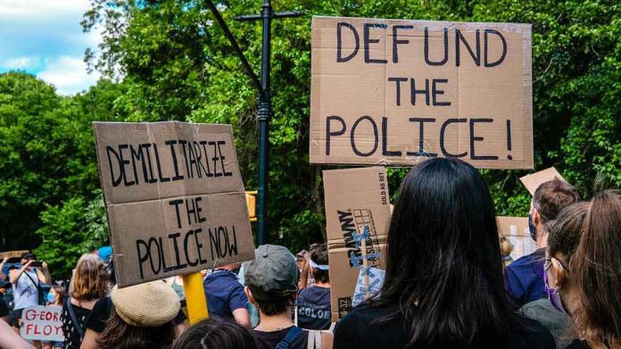 Protesters holding cardboard signs at a demonstration