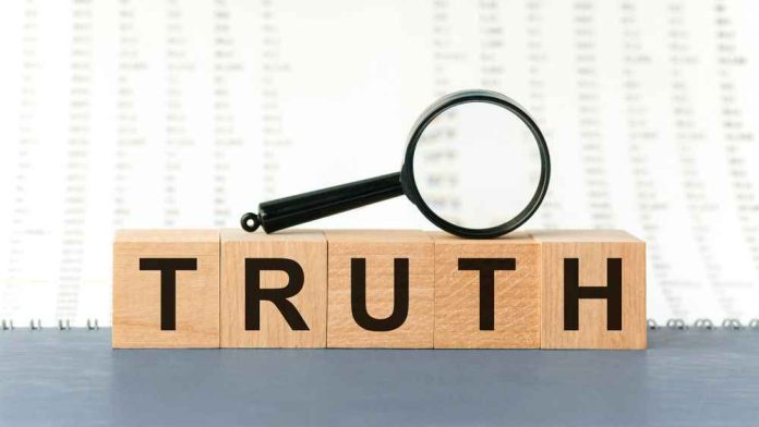 shutterstock_1868580070 Wooden blocks spelling truth with magnifying glass