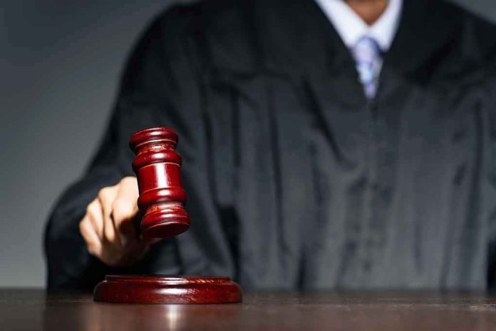 Judge with gavel striking sound block