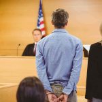 Killer’s Shocking REVERSAL Rattles MURDER Case Defendant in handcuffs stands before a judge in a courtroom