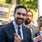 OUTRAGEOUS — NYC Mayor FINALLY SHOCKED Both Sides! A man speaking at a rally with supporters holding protest signs