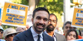 OUTRAGEOUS — NYC Mayor FINALLY SHOCKED Both Sides! A man speaking at a rally with supporters holding protest signs
