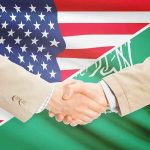 TRUMP’S Nuclear Deal — FULL IMPACT HERE… Handshake between two people over U.S. and Saudi flags