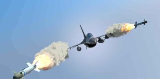 fighter jet firing two missiles in flight