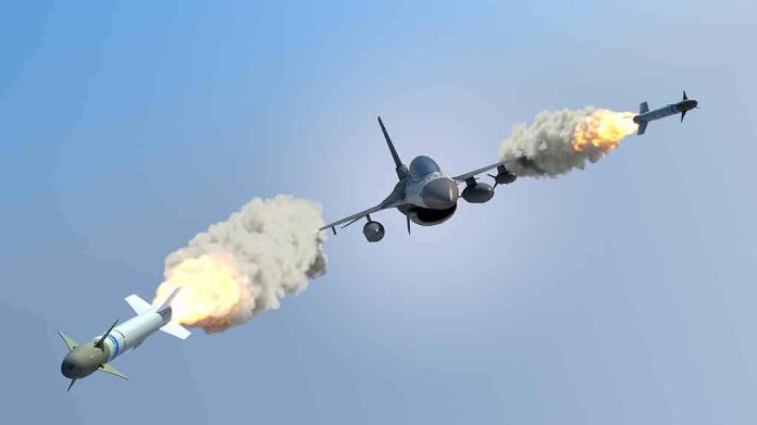 fighter jet firing two missiles in flight