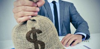 How China is FUNDING IRAN! Businessperson holding a burlap money bag on a desk