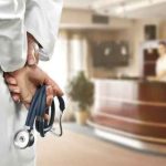 Pedophile PROTECTED, Nurse PUNISHED? A doctor holding a stethoscope behind their back in a hospital reception area