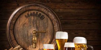 BELOVED BREWERY on the LINE — TRUTH FINALLY EXPOSED! assorted beer glasses in front of a wooden barrel