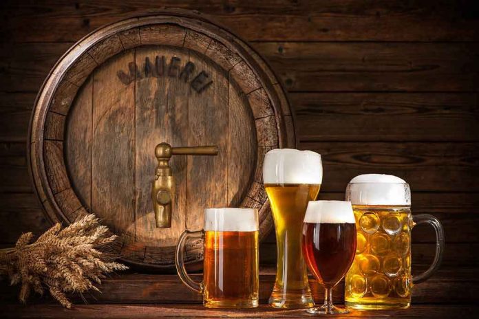 shutterstock_439117582 assorted beer glasses in front of a wooden barrel