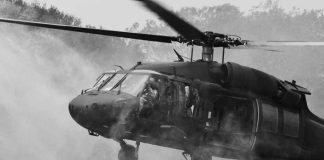 TERRIFYING: Black Hawks SWARM Camp — Kids Airlifted Out Military helicopter hovering with soldiers at open door