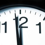 Clock Wars EXPLODE In Congress — FINALLY! Close-up of a clock showing the time just before noon