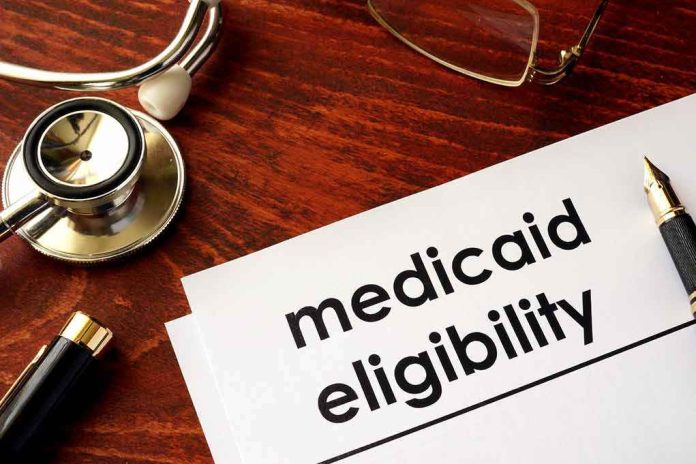 shutterstock_640488934-1 Medicaid eligibility form with stethoscope and pen on desk