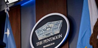 Pentagon FLEXES — Top General OUT The Pentagon emblem between two flags.