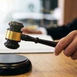 Court GREENLIGHTS Trump’s SHUTDOWN Judge's hand holding a gavel over a sound block