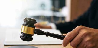 Court GREENLIGHTS Trump’s SHUTDOWN Judge's hand holding a gavel over a sound block