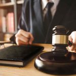 Brutal Ruling SHREDS Maxwell’s Bid Judge with gavel striking sound block