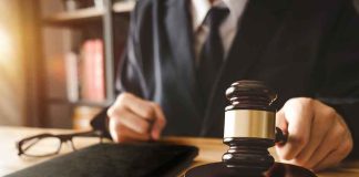 Brutal Ruling SHREDS Maxwell’s Bid Judge with gavel striking sound block