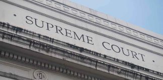 Supreme Court’s SNUB Leaves Trump On The Hook Supreme Court building facade with classical columns