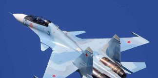 fighter jet in flight over clear blue sky