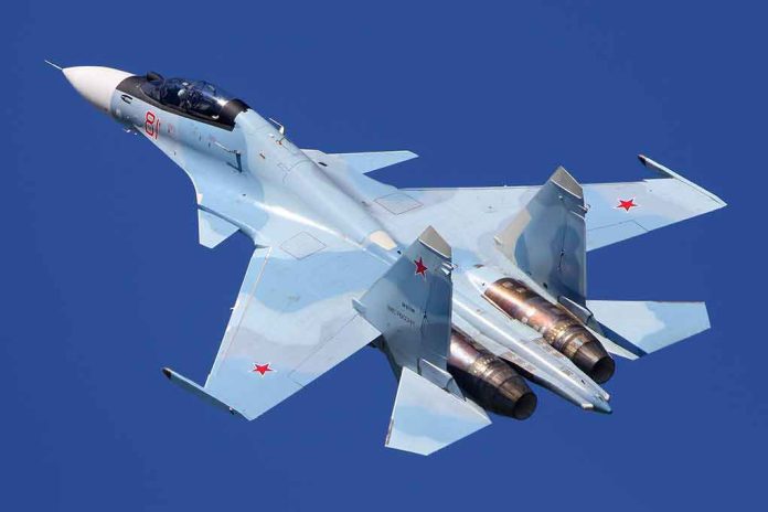 shutterstock_1091883563 fighter jet in flight over clear blue sky
