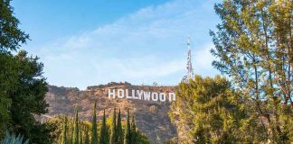 Hollywood Sign on hillside framed by trees
