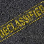 NEWLY Declassified Files RATTLE GOVERNOR Frontrunner Declassified stamp on rough asphalt surface