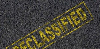 NEWLY Declassified Files RATTLE GOVERNOR Frontrunner Declassified stamp on rough asphalt surface