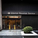 Shocking CRACKDOWN Looms For ELITE Nonprofits Entrance of the Internal Revenue Service office with signage