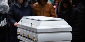MYSTERIOUS DEATH Haunts Prestigious UNIVERSITY White casket at an outdoor funeral