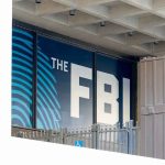 FBI Pounces After NEW Chilling TRUMP THREATS FBI sign on building facade behind metal fence